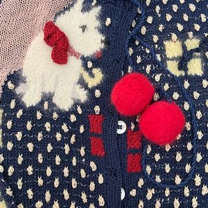 Had Knit Sweater with puppies and kitties knit into it.